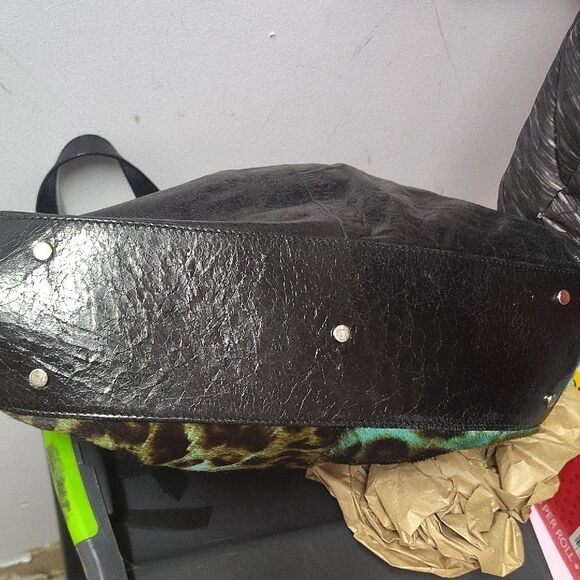 Brown and Black Shoulder Bag with Durable Fabric and Decorative Tassels - Picture 6 of 6